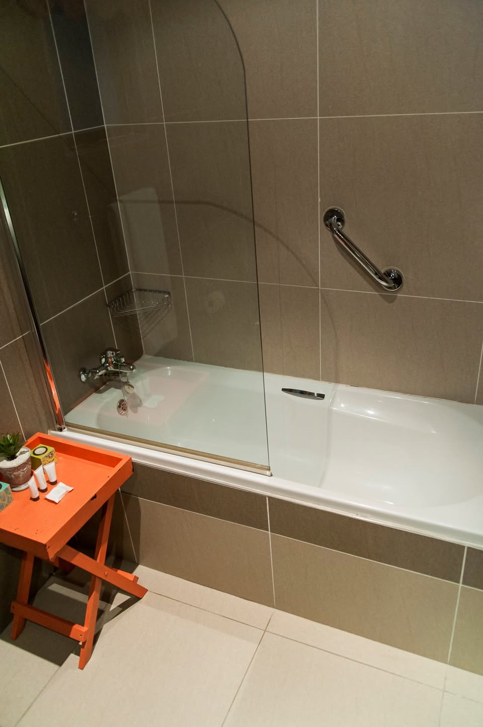 Bath tub with shower inside the bath.